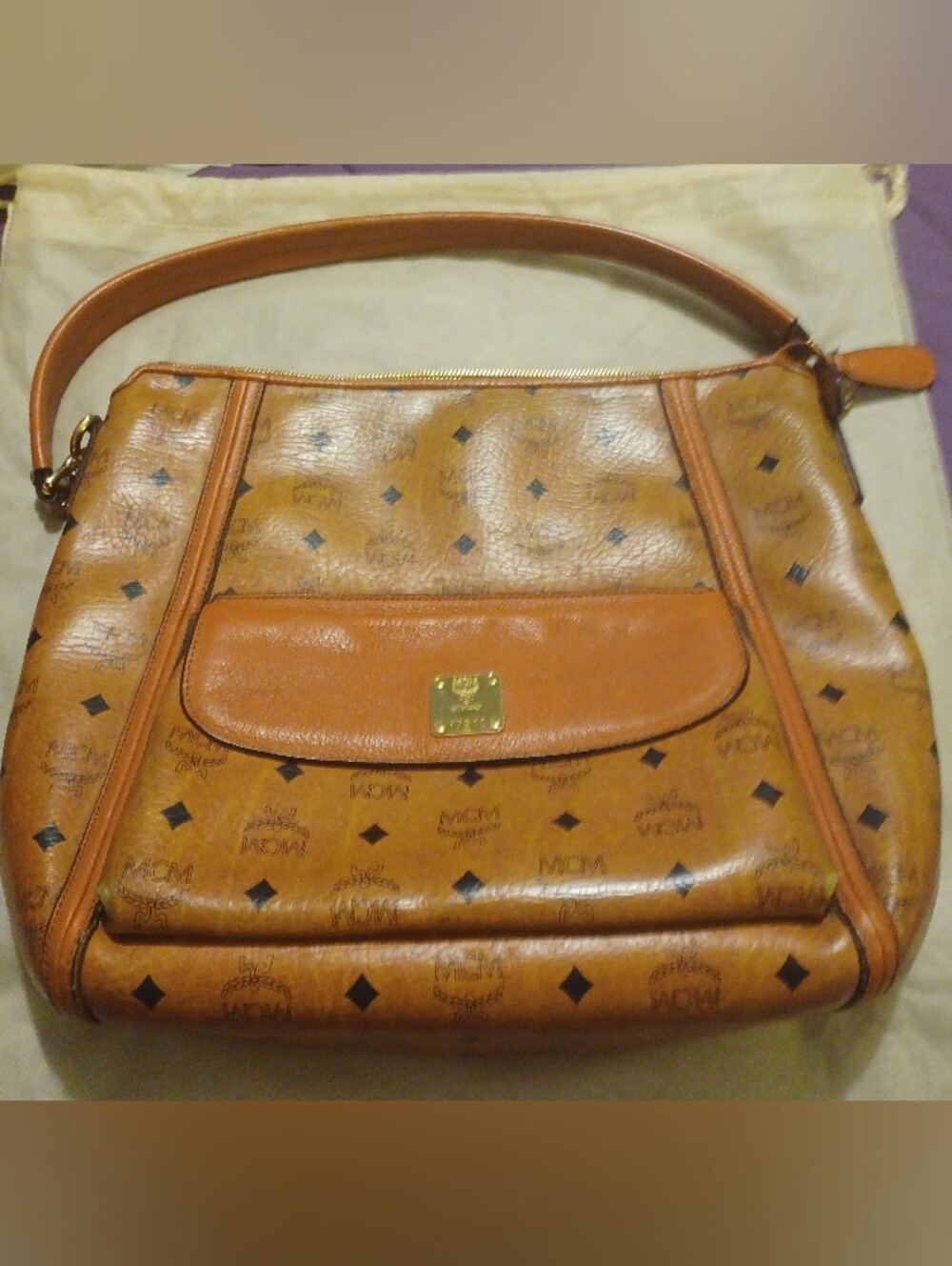 Authentic MCM Klara Hobo Bag In Cognac Visetos Monogram With Gold Hardware.